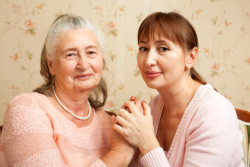 woman holding a hands of an old woman
